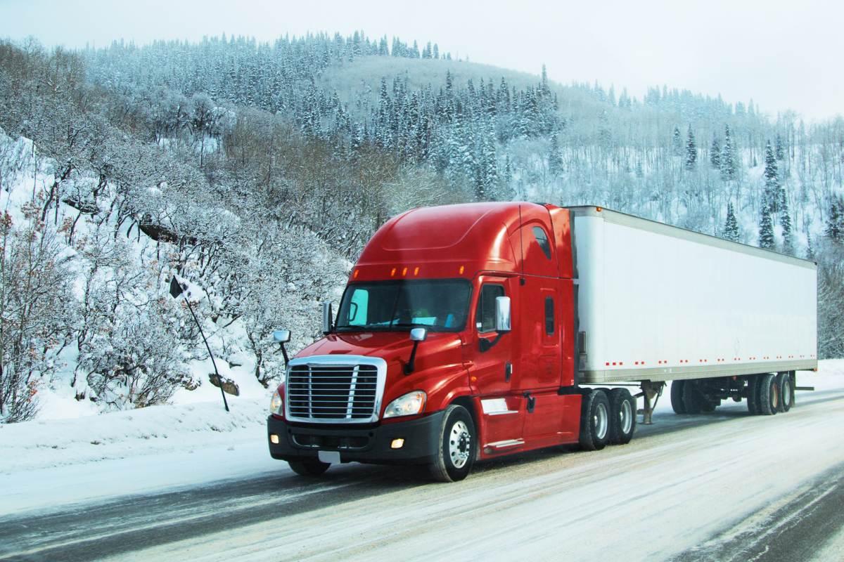 Premium shipping shown by a semi truck zooming on a snowy road.