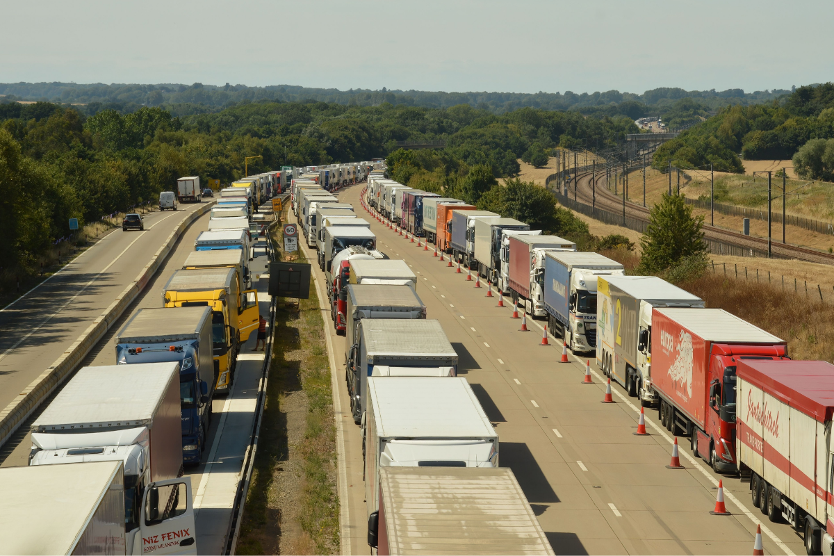 freight trucks stuck in heavy traffic at a distribution center